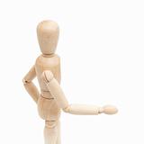 A wooden mannequin give a hand, greets.