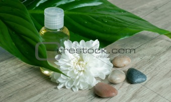 Essential oil with flower and stones.