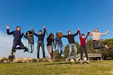 Group of Happy College Students Jumping at Park