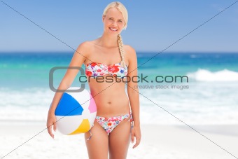 Woman with her ball on the beach