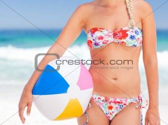 Woman with her ball on the beach