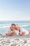 Mature couple lying down on the beach