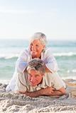 Senior couple lying down on the beach