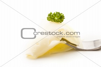 Slice of Cheese with parsley on fork