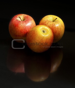 Three apples on black