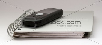 a telephone book and mobile phone