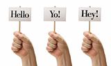 Three Signs In Male Fists Saying Hello, Yo! and Hey! Isolated on a White Background.