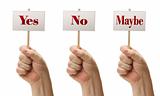 Three Signs In Male Fists Saying Yes, No and Maybe Isolated on a White Background.