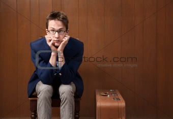 Young Man on Chair with Suitcase
