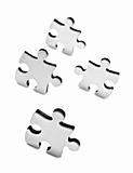 Stainless steel puzzles pieces on white background