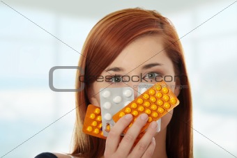 Young woman with pills