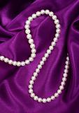 White pearls on a lilac silk 