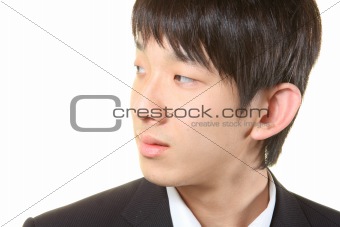 Young businessman standing and looking right,