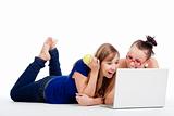 two young female friends having fun with laptop computer