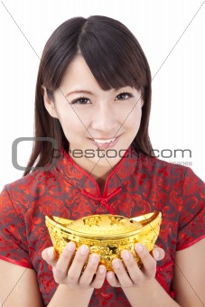 Beautiful asian woman wear cheongsam and holding chinese gold ingot