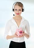 Young businesswoman holding piggy bank 