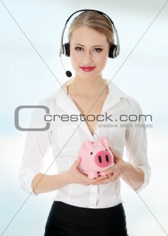 Young businesswoman holding piggy bank 