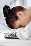 Businesswoman sleeping on the keyboard