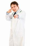 Cheerful medical doctor showing contact me gesture
