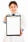 Smiling medical doctor holding blank clipboard in hands
