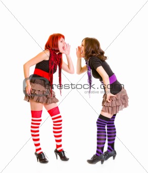 Two pretty young girlfriends shouting on each other
