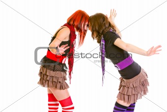 Two cheerful young girlfriends abuting foreheads
