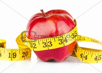 Red apple with measure tape on white background