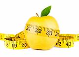Yellow apple surrounded by measuring tape