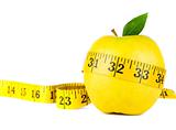 Yellow apple surrounded by measuring tape