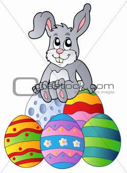 Bunny on pile of Easter eggs