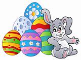 Bunny resting beside Easter eggs