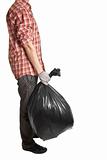 Man holding black plastic trash bag in his hand