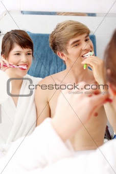 Young couple cleaning teeth