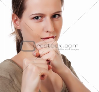 Young woman in fighting pose raising fists