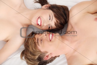 Beautiful couple lying in bed. 