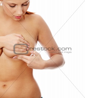 Young caucasian adult woman examining her breast
