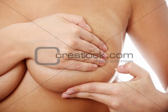 Young caucasian adult woman examining her breast