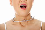 Young woman with barbed wire around her throat. 