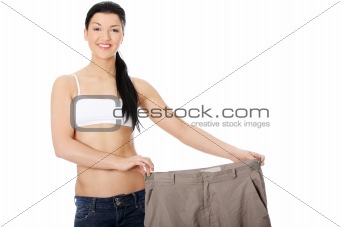 Young happy woman showing how much weight she lost