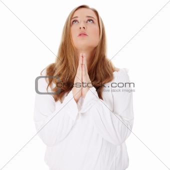 Closeup portrait of a young caucasian woman praying 