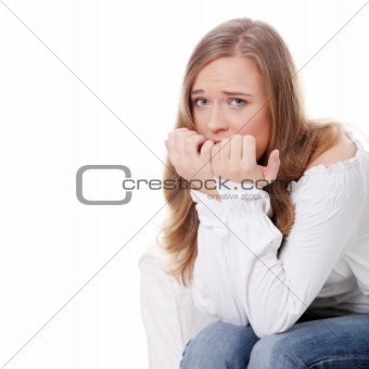 Stressed young woman eating her nails 