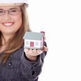 Young beautiful business woman with house model