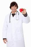 Happy handsome young male doctor holding heart.