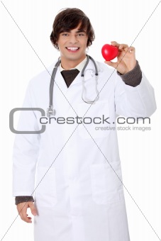 Happy handsome young male doctor holding heart.