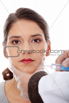 Plastic surgeons giving botox injection