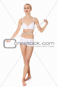 Woman measuring perfect shape of beautiful thigh waist.