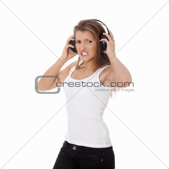 Emotional portrait of teen girl listening aggressive music