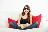 Beautiful young woman watching TV in 3d glasses