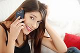 Beautiful young woman speaking by mobile phone