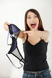 Angry woman with bra in hand.